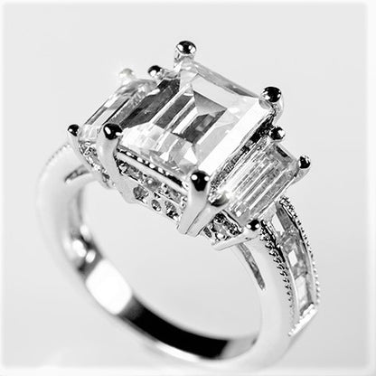 Alina 9x7mm Emerald CZ Three Stone Engagement Ring | 2.5ct | 3.7ct